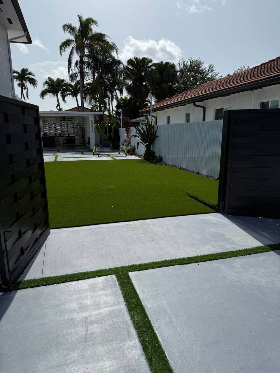 Modern courtyard turf strip installation