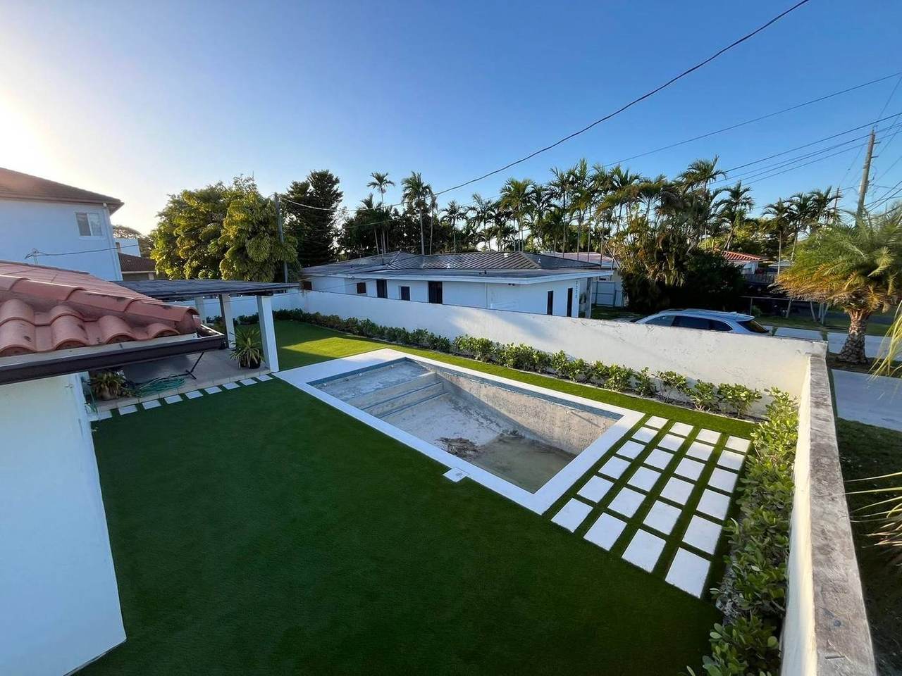 Backyard renovation with pool and turf installation in progress