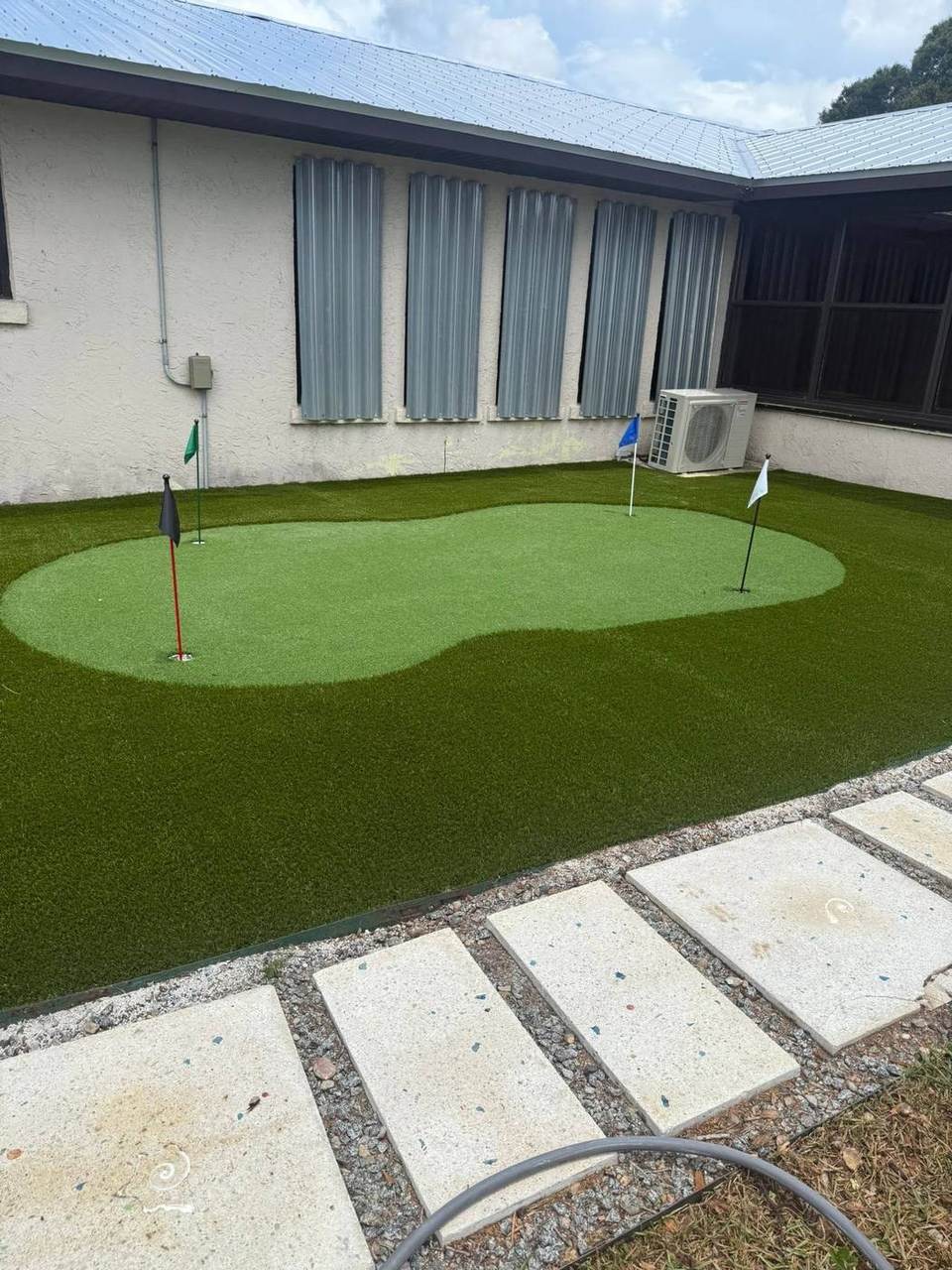 Backyard putting green turf installation