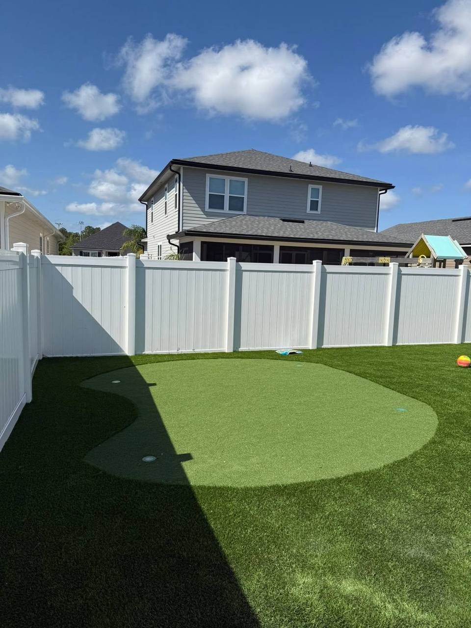 Backyard putting green with play area