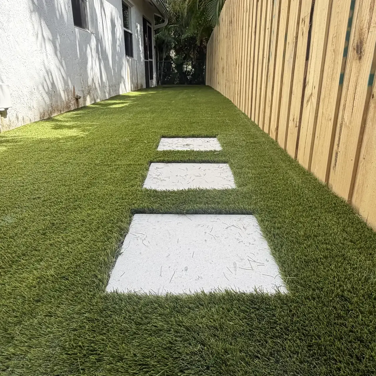 Side yard artificial turf with paver stepping stones